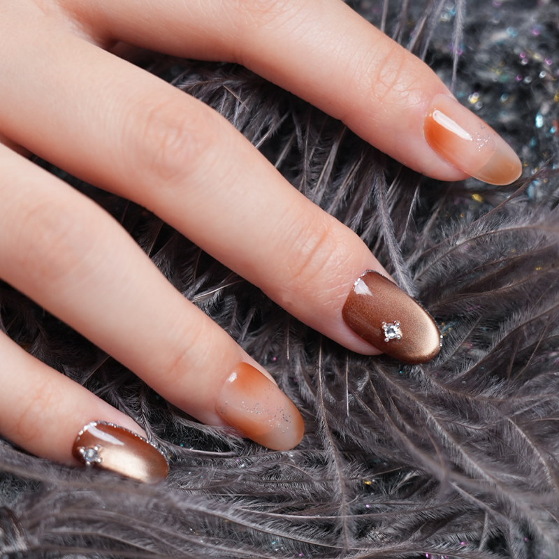 Gradient Brown Diamond-Accent Nails - Elegant Feather Background Manicure
